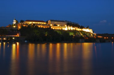 Petrovaradin fortress on river Danube, by night clipart