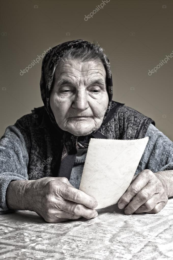 Elderly woman with old photos