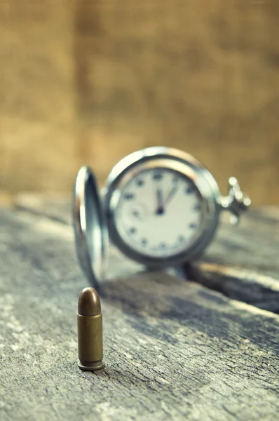 Bullet on wooden table — Stock Photo, Image