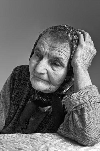 Portrait of sad lonely pensive old senior woman.