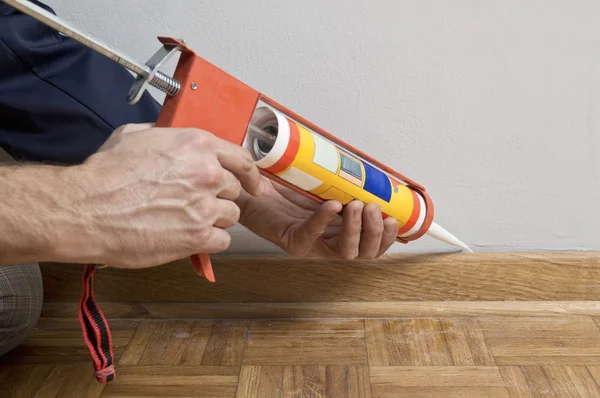 Caulking silicone on wooden batten. — Stock Photo, Image