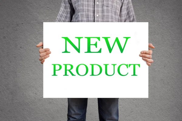 Person holding banner with black new product. — Stock Photo, Image