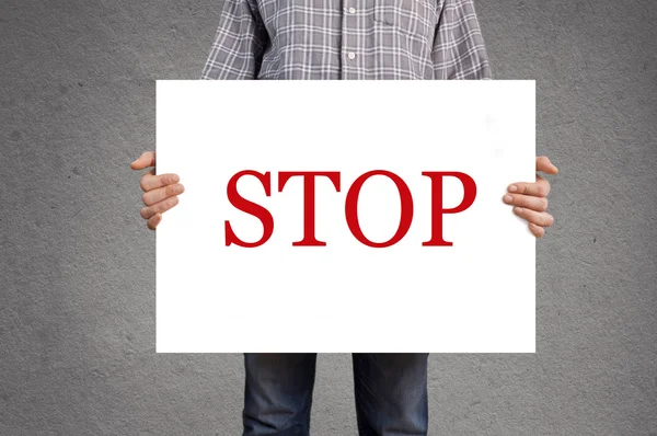 Person holding banner with STOP message — Stock Photo, Image