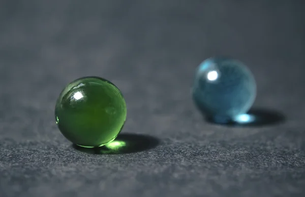 Glazen marmeren bollen geïsoleerd op donkere achtergrond. — Stockfoto