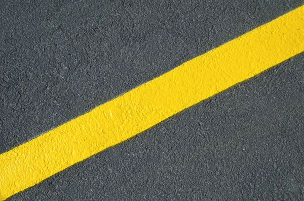 Yellow line on new asphalt detail — Stock Photo, Image