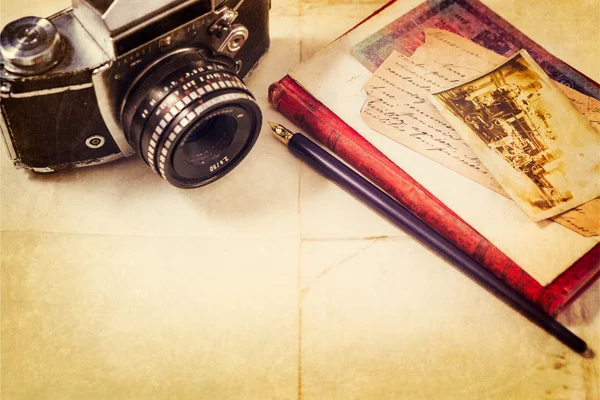 Background with vintage photo, money, postal card, and empty open book and camera — Stock Photo, Image