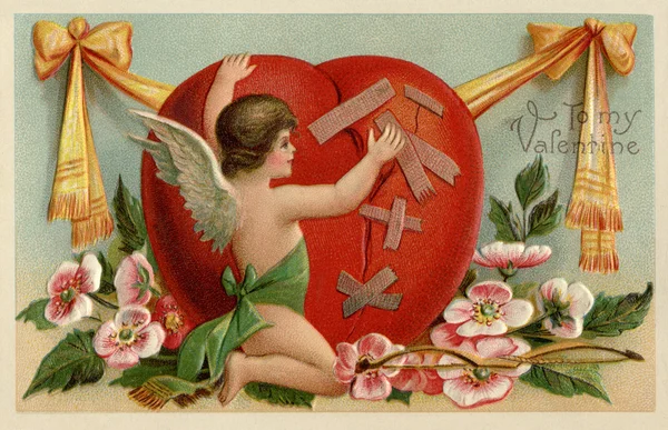 A vintage Valentines card with a cherub patching up a broken hea — Stock Photo, Image