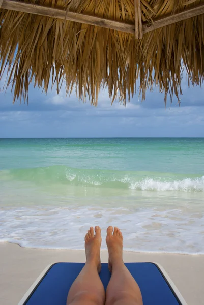 Relaxing under umbrella Stock Image