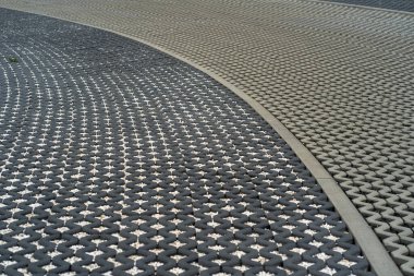 Concrete gray pavement tiles with empty squares filled with light and dark rubble, background image, repeating geometric shapes, road, natural gray geometric background, selective focus, copy space