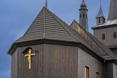 Black wood catholic christian temple on a cloudy day, dramatic rainy sky, sacrament of faith, christian temple geometry, catholic religion