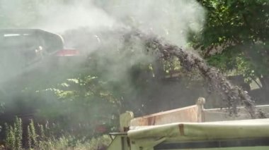 Replacing old asphalt when repairing the road surface. A road car removes the old asphalt and puts it in the back of a truck. Road repair and reconstruction in Europe