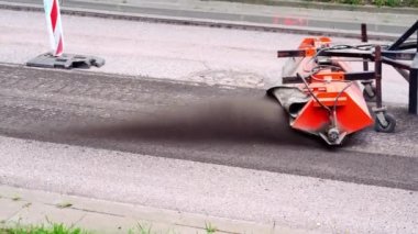 Replacing old asphalt when repairing the road surface. Road machine cleans old pavement for laying new asphalt. Repair and reconstruction of roads in Europe