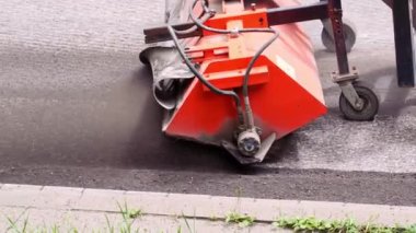 Replacing old asphalt when repairing the road surface. Road machine cleans old pavement for laying new asphalt. Repair and reconstruction of roads in Europe. Close-up