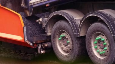 Replacing old asphalt when repairing the road surface. Asphalt paver lays bitumen and new hot asphalt. Road repair in Europe. Repair and reconstruction of the road surface in Poland.