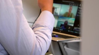 A man works on a laptop during a train ride, a young businessman works on the road while traveling, digital technology in real life, 4K (UHD) slow motion video