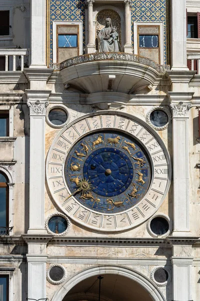 Saint Mark\'s Clock Tower in Saint Mark\'s Square (Piazza San Marco), Venice, vintage clock with golden zodiac signs and Roman dial, early Italian Renaissance architectural monument in Venice