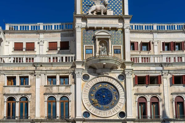 Saint Mark\'s Clock Tower in Saint Mark\'s Square (Piazza San Marco), Venice, vintage clock with golden zodiac signs and Roman dial, early Italian Renaissance architectural monument in Venice