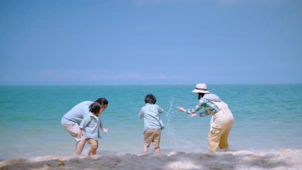 アジアの家族は喜んでリラックスの休暇でビーチでからかっています 家族関係の概念 リラクゼーション — ストック動画