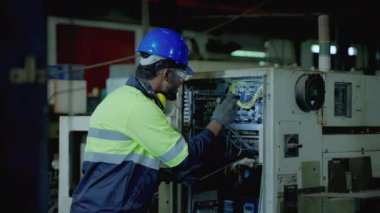 Kafkas bakım mühendisi, endüstriyel bir tesiste normal işleyişi sürdürmek için kontrol kabinesini yakmak için bir meşale kullanıyor..