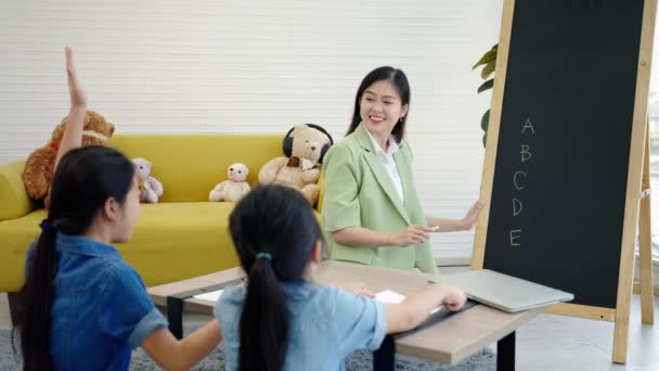 Die Tutorin Unterrichtet Schüler Der Nachhilfeschule Sie Bringt Asiatischen Kindern — Stockvideo