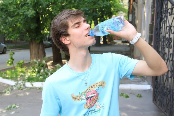 Thirsty young man — Stock Photo, Image