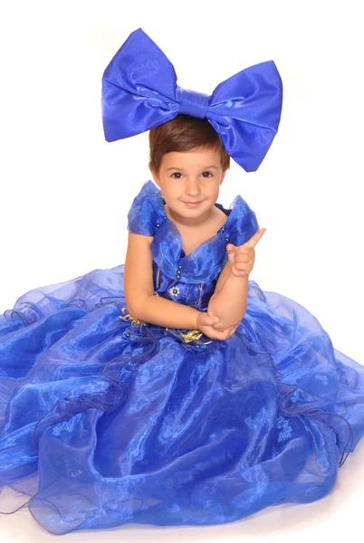 Cute girl in blue dress with a bow — Stock Photo, Image