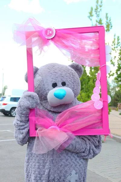 Holiday teddy bear with a pink frame — Stock Photo, Image