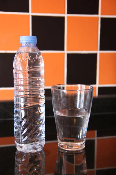 Plastic bottle of water and glas