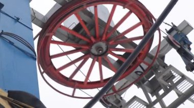 Working red wheel of the lift in the ski complex
