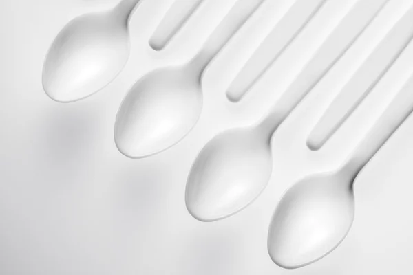 Pattern of white spoon on white background — Stock Photo, Image
