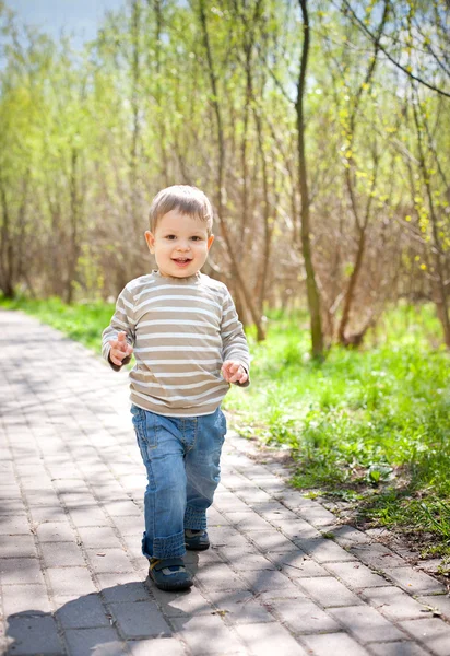 Cute child boy walking on road — Stock Photo, Image