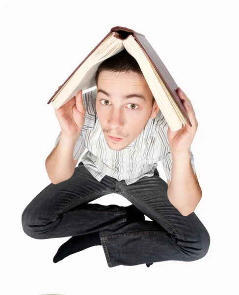 Estudiante sosteniendo un libro sobre su cabeza —  Fotos de Stock