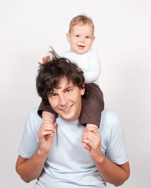 Baby sitting on father neck on white — Stock Photo, Image