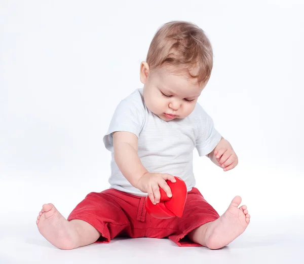 Bebê brincando com o coração de quebra-cabeça no branco — Fotografia de Stock