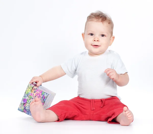 Baby boy opening gift box on white — Stock Photo, Image