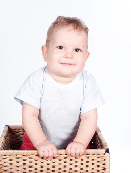 Baby boy in wicker basket on white — Stock Photo, Image