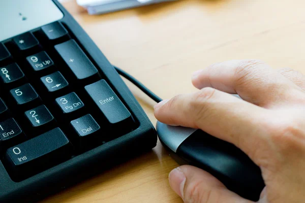 Human hand on computer mouse — Stock Photo, Image