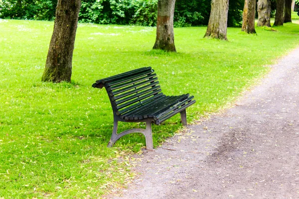 Stylish bench in summer park — Stock Photo, Image