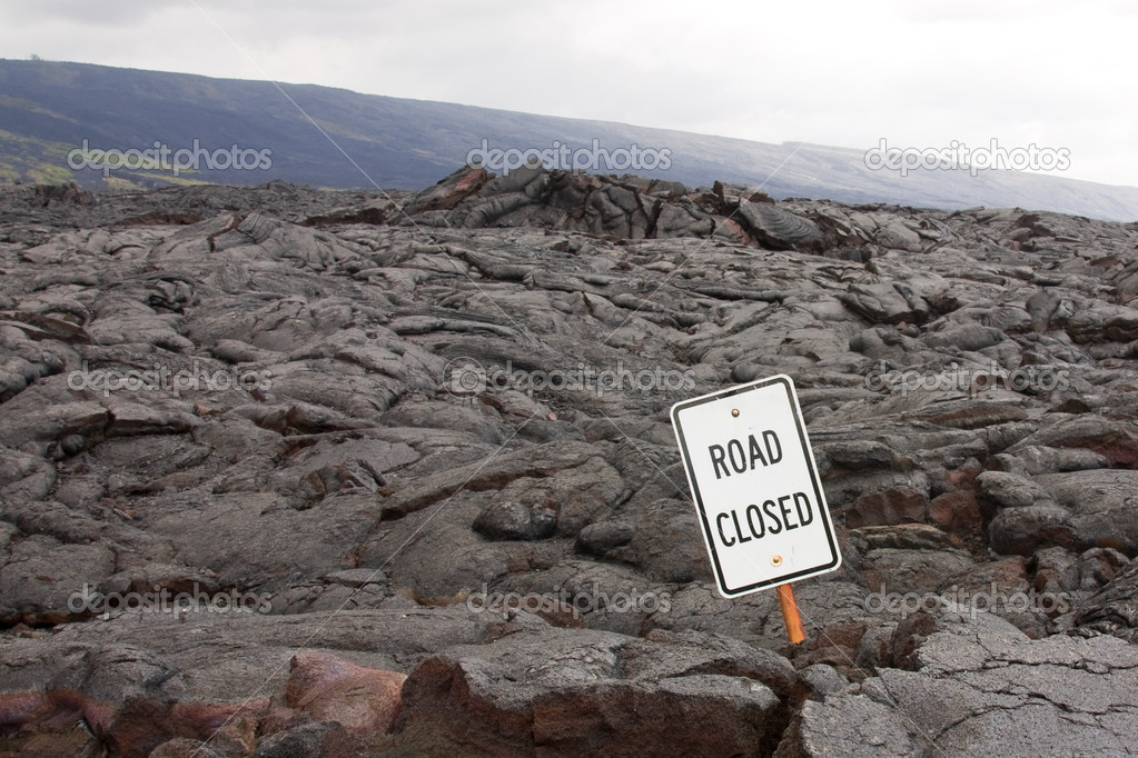 'Road closed' sign in the middle of a lava flow