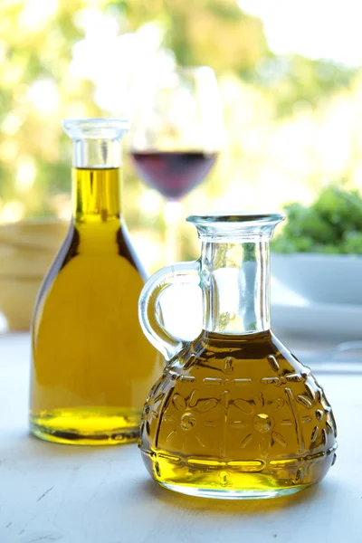 Olive oil on the table with natural background — Stock Photo, Image