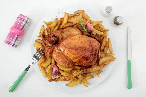 Roast chicken and potatoes on the white table — Stock Photo, Image