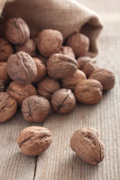 Walnuts on wooden table — Stock Photo, Image