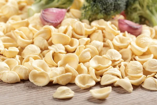 Italian pasta orecchiette on the rustic table — Stock Photo, Image