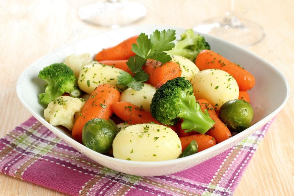 Boiled mixed vegetables with carrots potato and broccoli Stock Photo by