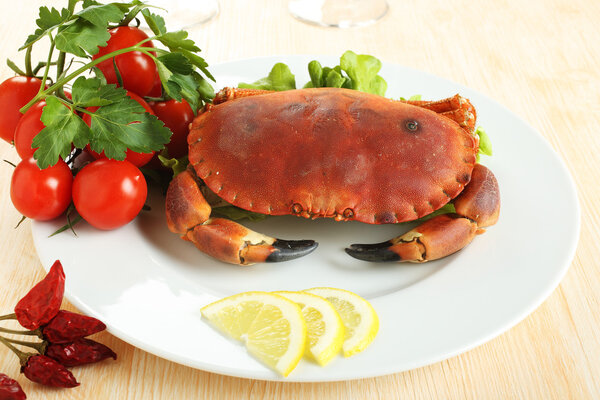 raw crab with tomatoes and lemon on dish