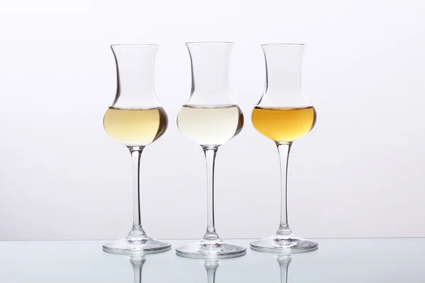 Cocktails drie glas met tequila, rum of grappa op grijze achtergrond — Stockfoto