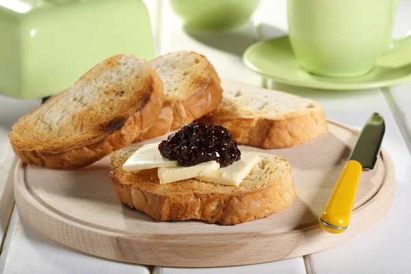 Butter with fruit jam on bread toast green ceramic background — Stock Photo, Image