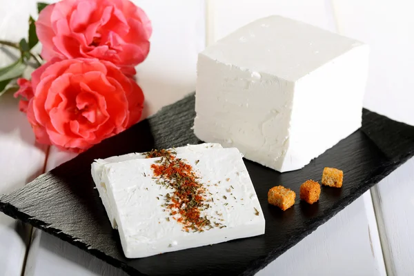 Cheese feta on black stone — Stock Photo, Image