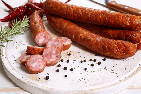 Sausages on white wooden table — Stock Photo, Image