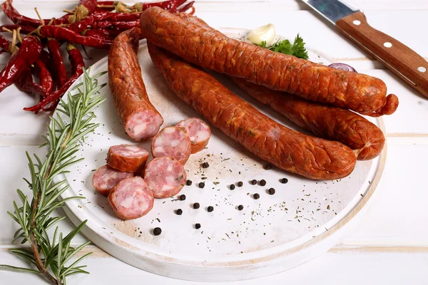 Sausages on white wooden table — Stock Photo, Image